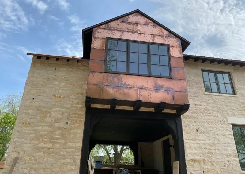 Copper metal panel facade on a stone building for Skylight Installation in Huntington Park