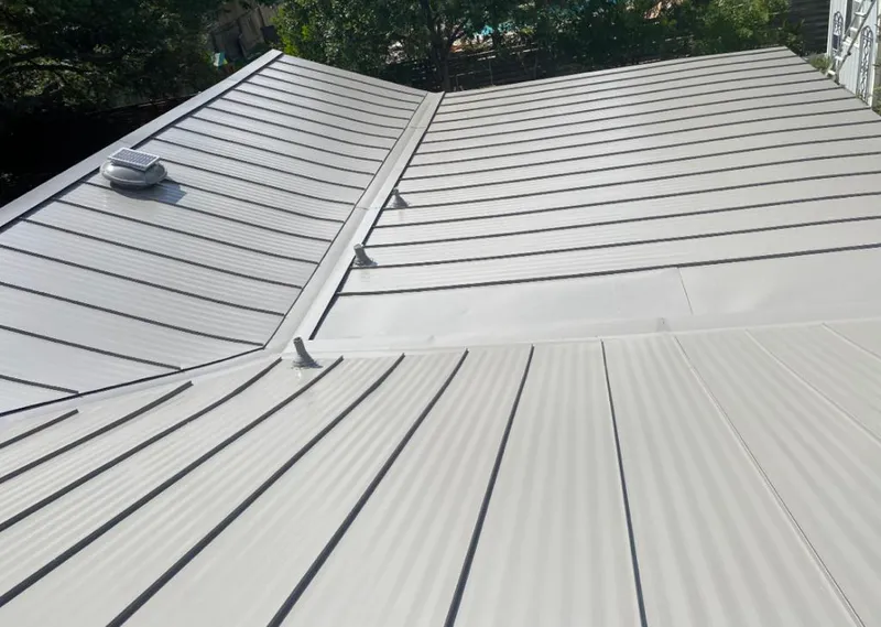 Solar attic fan installed on a metal roof for Roof Ventilation in Huntington Park